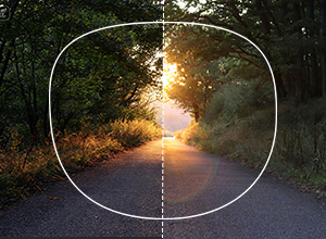 Polarized lenses half‑covering a reflective surface to show glare elimination