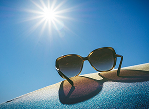 Dark sunglass lenses under bright sunlight offering full UV protection